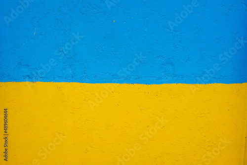 concrete wall painted in yellow and blue like Ukrainian flag, the country of victim of the aggressor