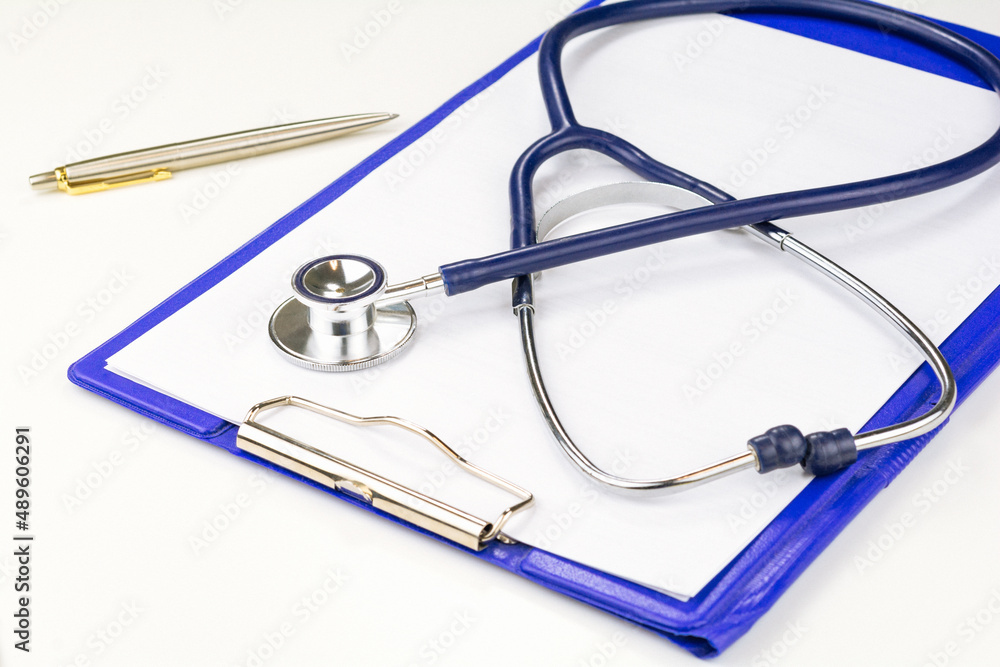 Blank white paper of note book with pen, Stethoscope, pen and blank prescription pad. Medicine or pharmacy. Modern medical Information technology. Blank white paper of note book with pen, Stethoscope, pen and blank prescription pad. Medicine or pharmacy. Modern medical Information technology.