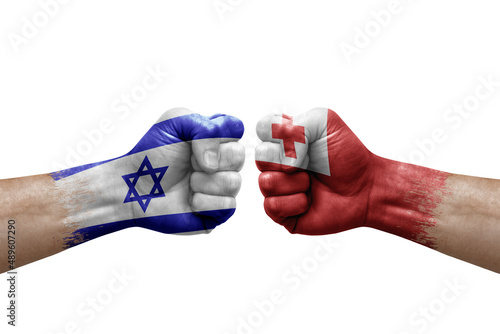 Two hands punch to each others on white background. Country flags painted fists, conflict crisis concept between israel and tonga