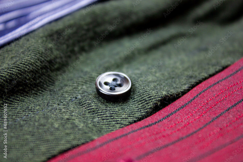 Cotton shirts. Close-up of the fabric of a men's shirt. Assortment of shirts background. Cotton shirts. Close-up of the fabric of a men's shirt. Assortment of shirts background.