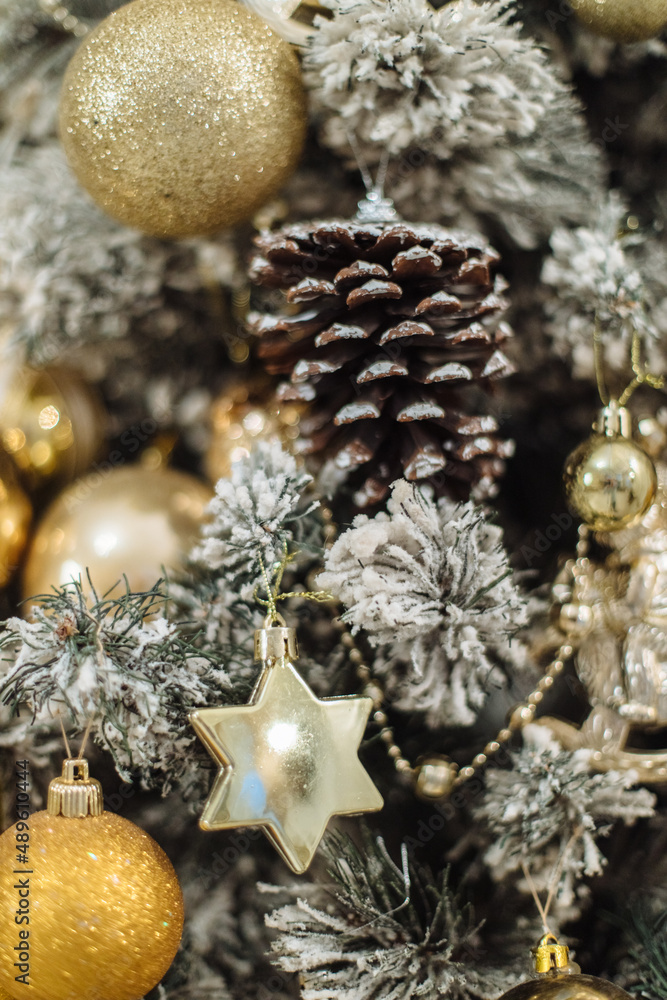 Close-up of the Christmas tree background with toys. Christmas bell, fir cones on the branches of a tree. Christmas decor. The concept of a winter holiday. Happy New Year. Close-up of the Christmas tree background with toys. Christmas bell, fir cones on the branches of a tree. Christmas decor. The concept of a winter holiday. Happy New Year.