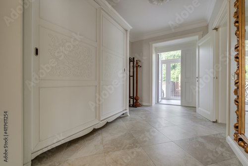 long corridor in interior of entrance hall of modern apartments with doors, cabinets, shelves and a mirror © hiv360