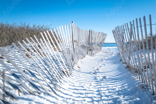 Snow fences on the beach. Beach access at the Atlantic Ocean on Cape Cod. 