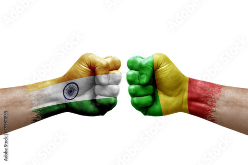 Two hands punch to each others on white background. Country flags painted fists, conflict crisis concept between india and mali