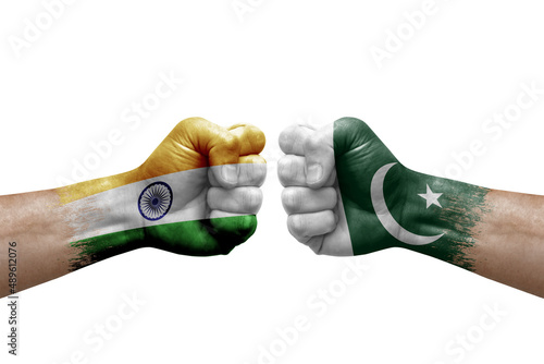 Two hands punch to each others on white background. Country flags painted fists, conflict crisis concept between india and pakistan