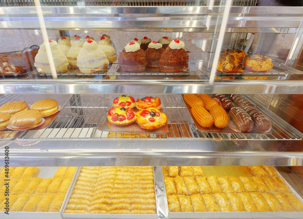 The pastry aisle. Shot of pastry behind window glass at a bakery.