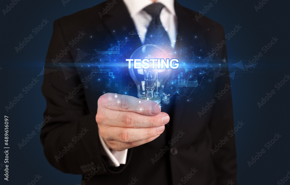 Fototapeta premium Businessman holding a light bulb