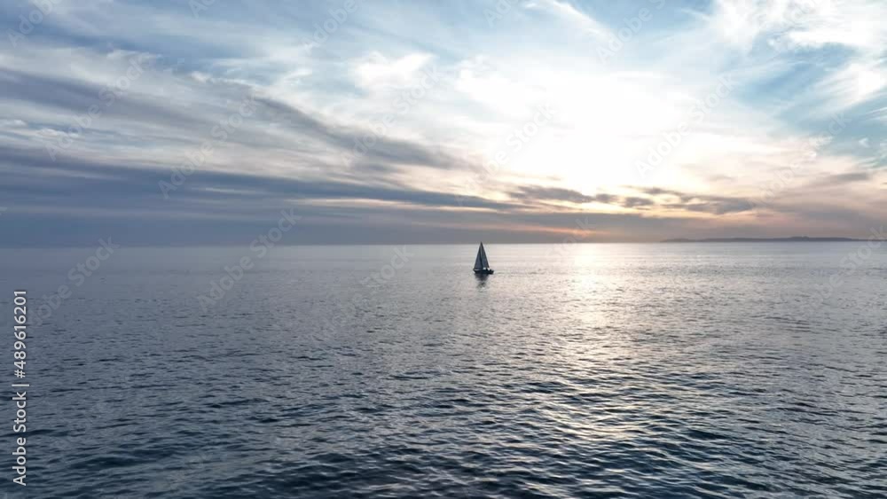 Sailboat in the sea in the sunlight, luxury summer adventure, active vacation in ocean. Sail boat on ocean waves. Sailboat in the sea in the sunlight, luxury summer adventure, active vacation in ocean. Sail boat on ocean waves.