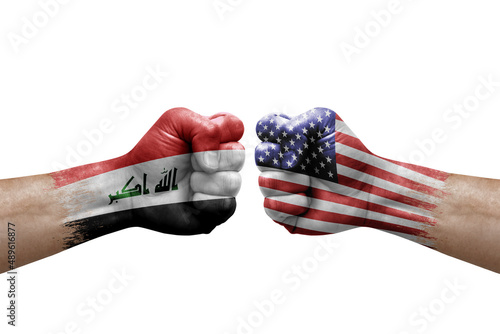 Two hands punch to each others on white background. Country flags painted fists  conflict crisis concept between iraq and usa