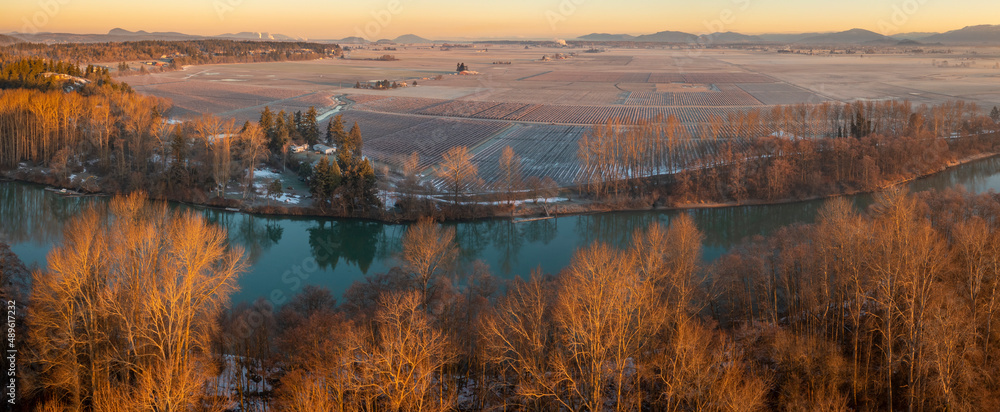 Aerial View of the Skagit River During a Brilliant Sunrise. The Skagit River runs from high in the Cascade Mountains to Puget Sound. The Skagit floodplain is one of the richest agricultural areas.
