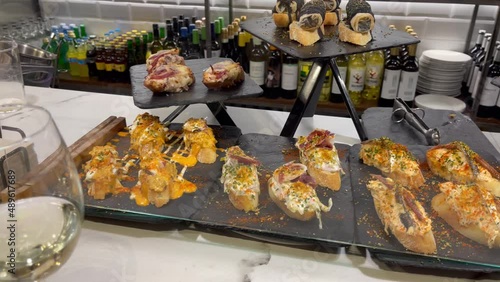 Restaurant bar full of plates with variety of pintxos. Traditional tapas food from Basque Country