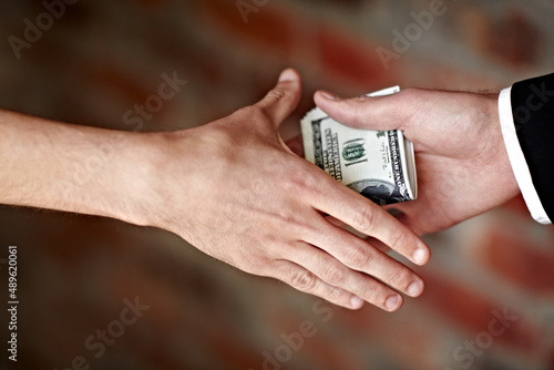 Receiving a bribe. Cropped shot of hands receiving an illegal payoff.