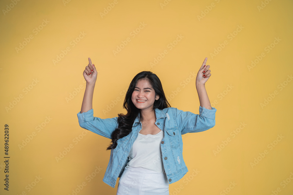 young woman with two finger pointing up young woman with two finger pointing up