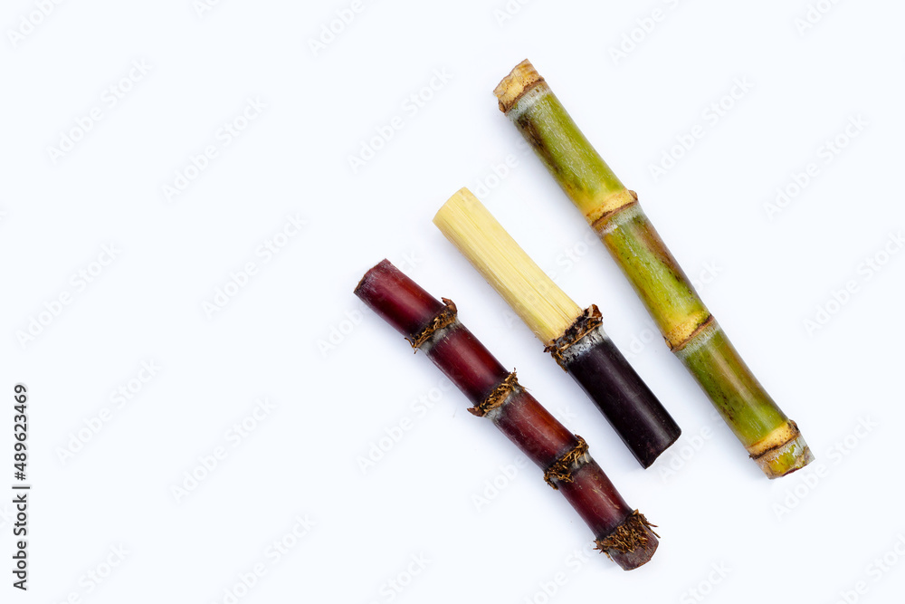 Sugar cane with brown sugar on white background Sugar cane with brown sugar on white background