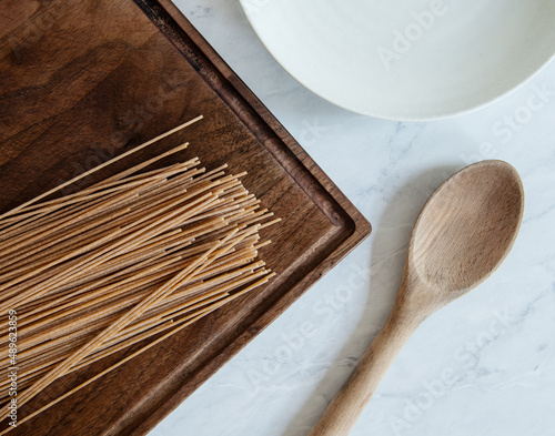 Dry whole wheat pasta with a wooden spoon  photo