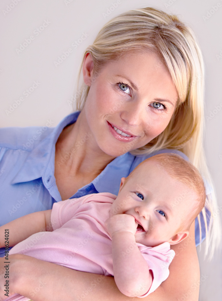 Perfect portrait. Young mother holding her cute baby while smiling at the camera. Perfect portrait. Young mother holding her cute baby while smiling at the camera.