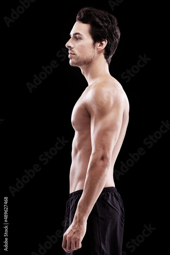 Handsome and brooding. Studio shot of a bare-chest and fit young man.
