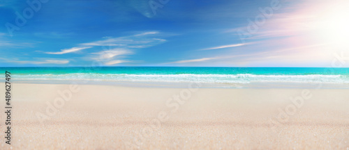 Fototapeta Naklejka Na Ścianę i Meble -  Seascape beach background. Blue sea in clear sky day. Focus on sand foreground.