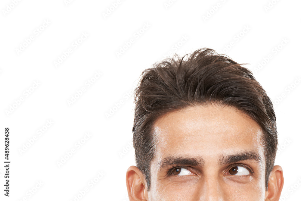 Inquisitive about your copyspace. Cropped shot of a young mans face looking sideways towards copyspace. Inquisitive about your copyspace. Cropped shot of a young mans face looking sideways towards copyspace.