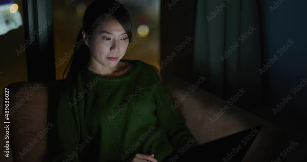 Woman work from home with her computer at night