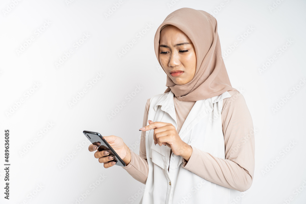 muslim woman shocked while using mobile phone muslim woman shocked while using mobile phone