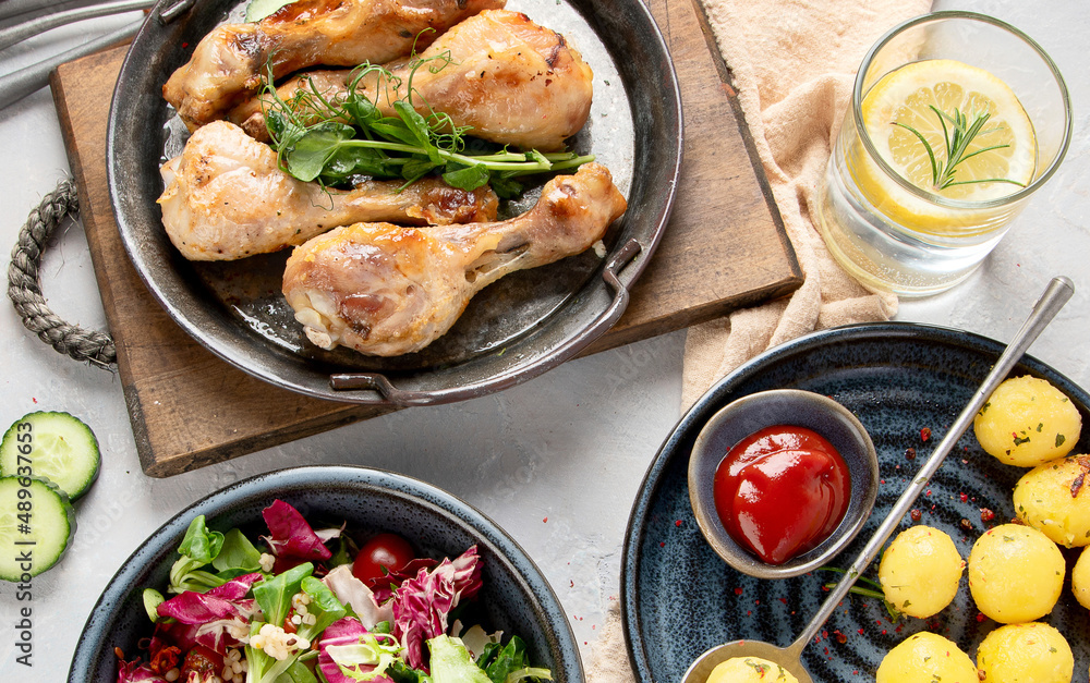 Baked chicken legs with salad and potatoes Baked chicken legs with salad and potatoes