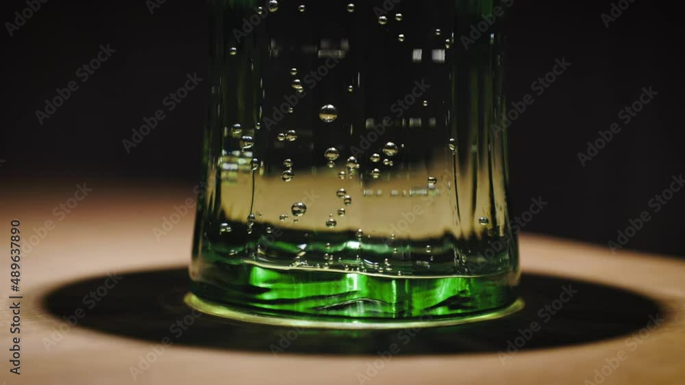 carbonated mineral water in a green glass close-up