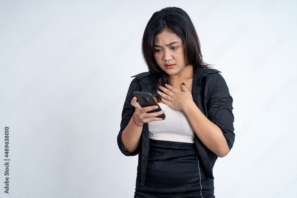 young woman shocked while using mobile phone young woman shocked while using mobile phone