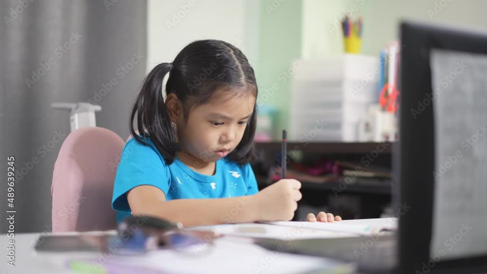 asian child student back to school by studying online or kid girl writing and read on book with computer laptop to doing homework and learning write by video call or person learn from home on notebook asian child student back to school by studying online or kid girl writing and read on book with computer laptop to doing homework and learning write by video call or person learn from home on notebook