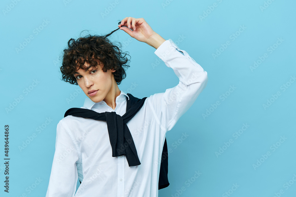 student in a white shirt sweater on the shoulders blue background student in a white shirt sweater on the shoulders blue background