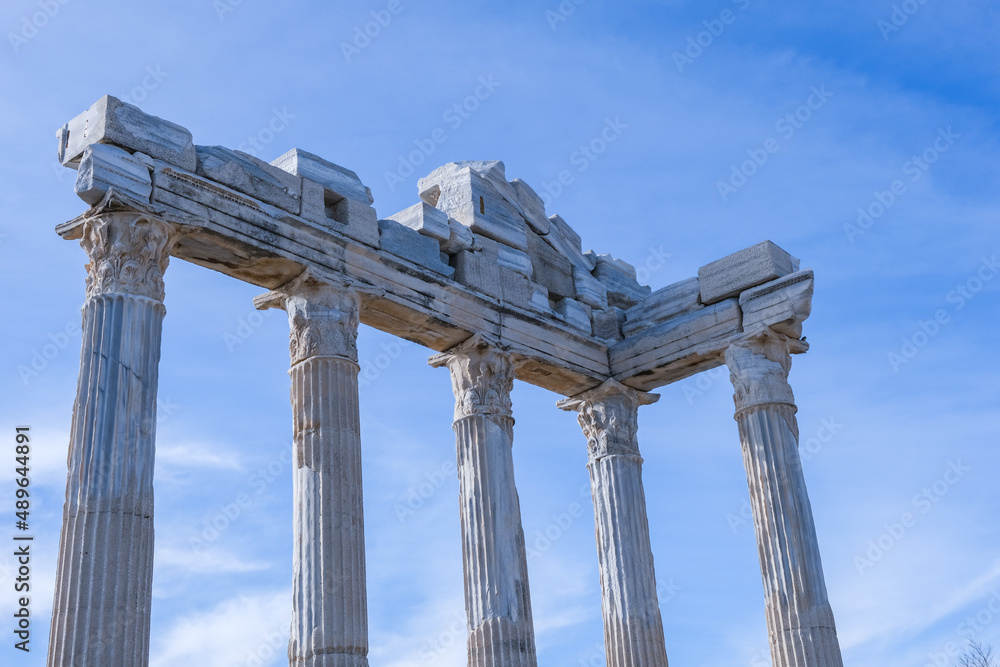 Temple of Apollo with blue sky background, Greek and Roman ancient historical antique marble columns in Side Antalya Turkey, close-up shot, copy space.