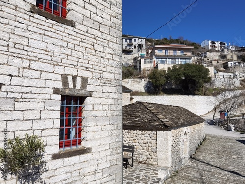 igiades village on the mountain mitsikeli, greek fllag waving old traditional houses in ioannina photo