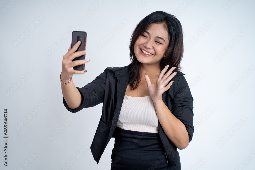 young woman make a video call with saying hello gesture young woman make a video call with saying hello gesture
