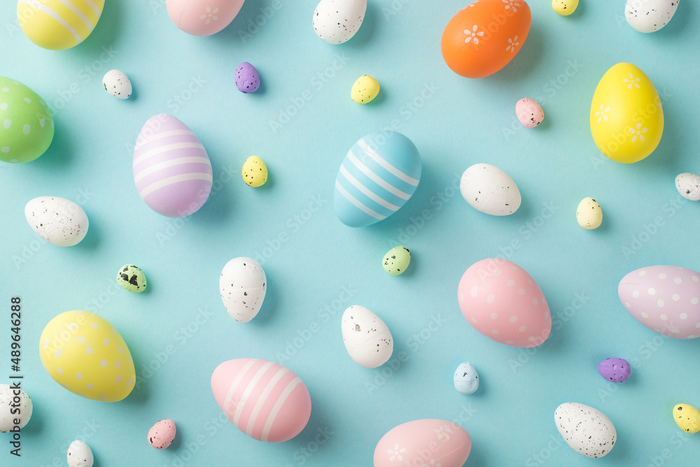 Top view photo of easter decorations multicolored easter eggs on isolated pastel blue background
