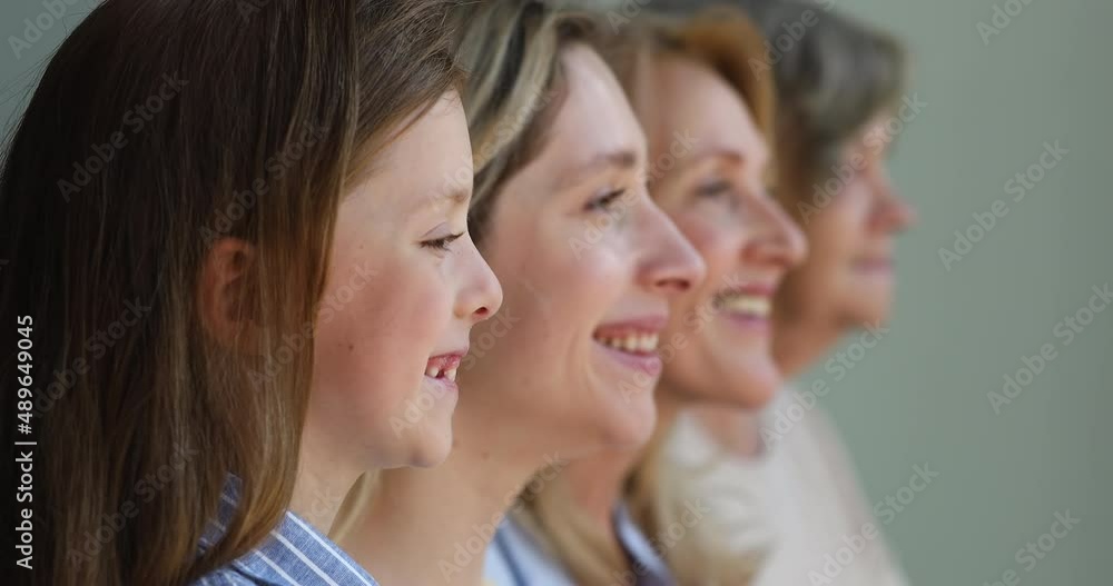 Close up profile faces in row in perspective, forefront view of little 6s girl, her young mother, grandmother and great-grandma. Multi generational women family portrait, offspring, motherhood concept Close up profile faces in row in perspective, forefront view of little 6s girl, her young mother, grandmother and great-grandma. Multi generational women family portrait, offspring, motherhood concept