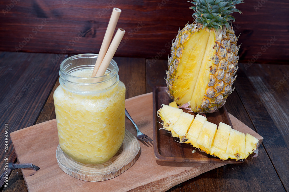 Iced pineapple juice in a glass, sliced pineapple. (hea… Stock Photo