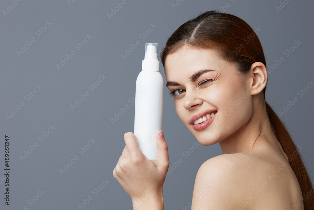 woman body lotion rejuvenation cosmetics Gray background woman body lotion rejuvenation cosmetics Gray background