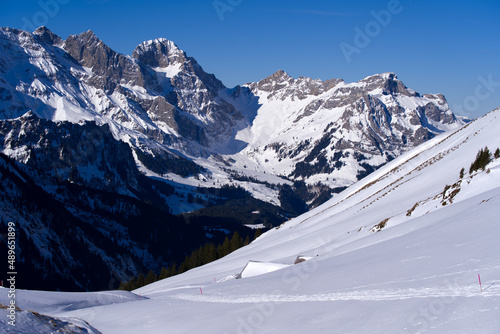 Aerial view of mountain panorama at the Swiss Alps seen from ski resort Engelberg, focus on background. Photo taken February 9th, 2022, Engelberg, Switzerland.