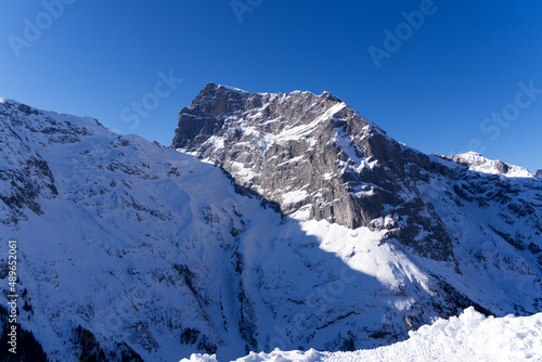 Famous Mount Titlis 3,238 meters above sea level at ski resort Engelberg in the Swiss Alps on a sunny winter day. Photo taken February 9th, 2022, Engelberg, Switzerland.