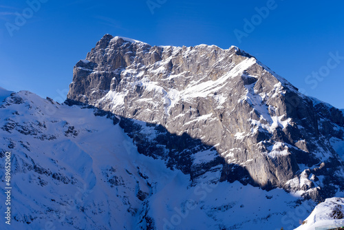 Famous Mount Titlis 3,238 meters above sea level at ski resort Engelberg in the Swiss Alps on a sunny winter day. Photo taken February 9th, 2022, Engelberg, Switzerland. © Michael Derrer Fuchs