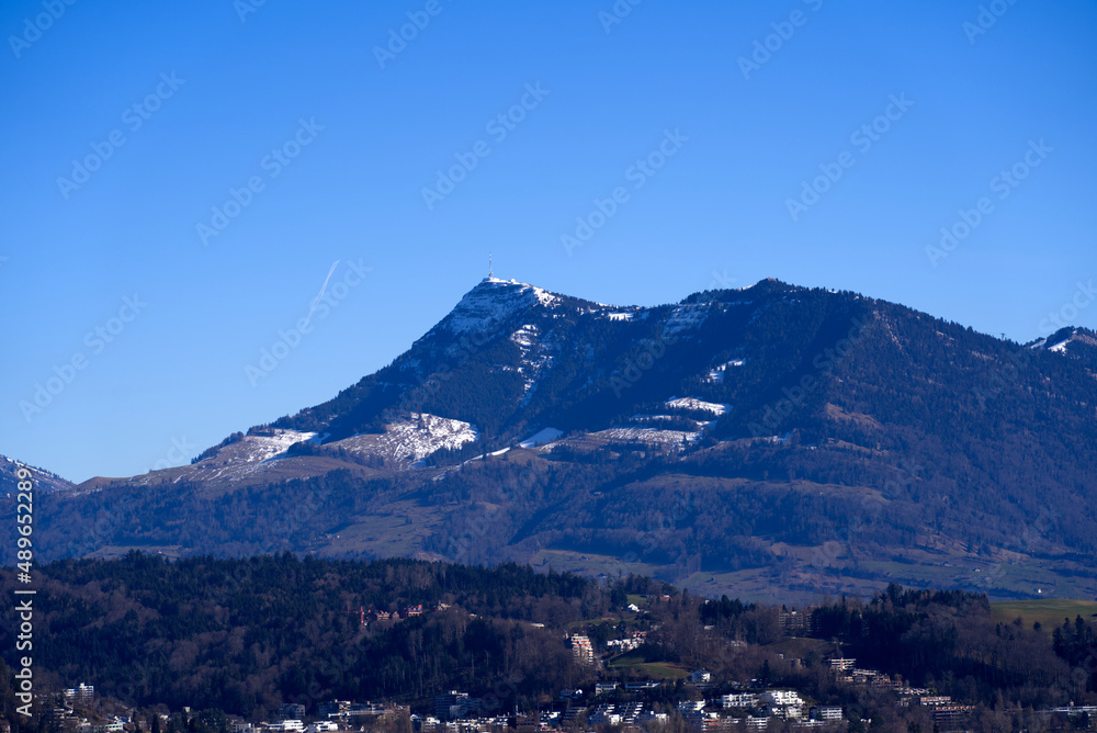 Aerial view of Swiss Alps seen form local mountain Gütsch at City of Lucerne on a sunny winter day. Photo taken February 9th, 2022, Lucerne, Switzerland.