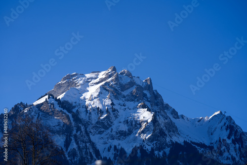 Aerial view of mountain panorama at the Swiss Alps seen from ski resort Engelberg, focus on background. Photo taken February 9th, 2022, Engelberg, Switzerland. © Michael Derrer Fuchs