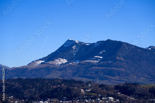 Aerial view of Swiss Alps seen form local mountain Gütsch at City of Lucerne on a sunny winter day. Photo taken February 9th, 2022, Lucerne, Switzerland.