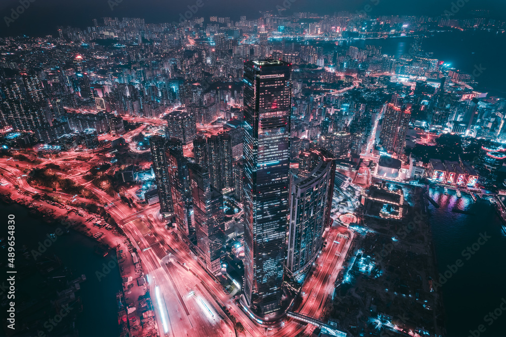 Fototapeta premium Aerial view of Hong Kong Downtown. Financial district and business centers in smart city, technology concept. Top view of skyscraper and high-rise buildings at night.