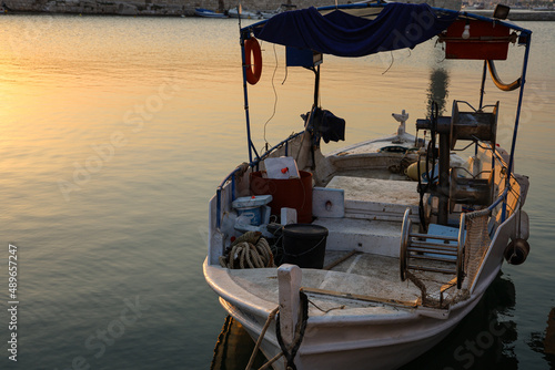 Beautiful shot of a fisher boat at a calm greek habor in the old town of Rethymno in Crete, Greece