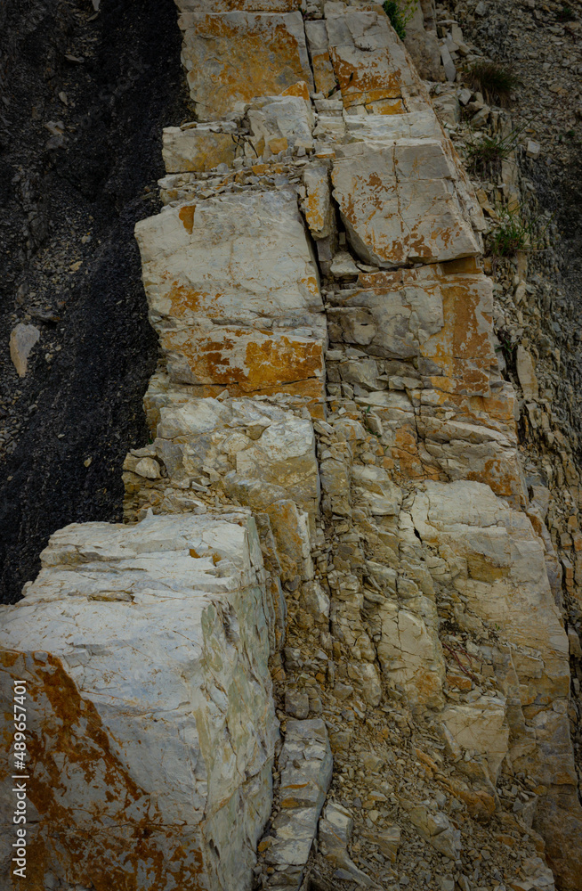 Natural dark background. Detail of the dolomite rock. Vertical image.