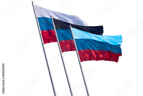 Flags of Russia and the partially recognized republics of Donetsk and Lugansk oblasts isolated on a white background. Close-up of banners fluttering in the wind. photo