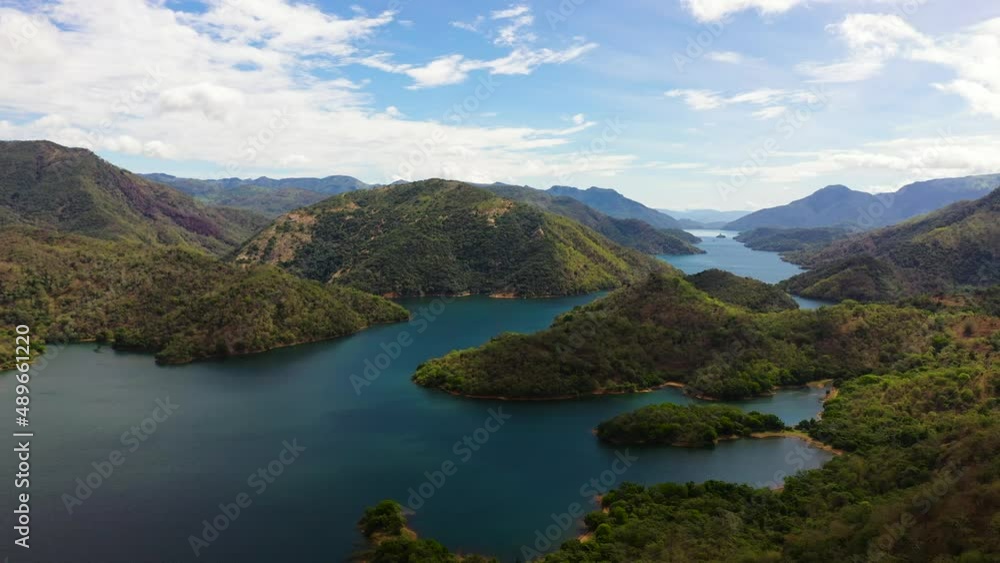 Top view of lake among mountains and hills with a forest against the sky and clouds. Randenigala reservoir, Sri Lanka. Top view of lake among mountains and hills with a forest against the sky and clouds. Randenigala reservoir, Sri Lanka.