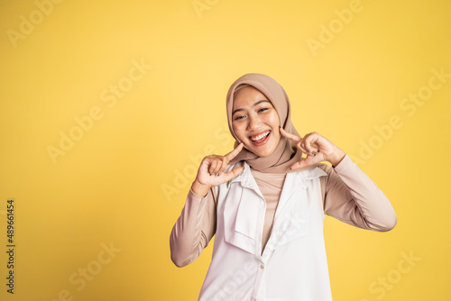 excited happy woman with headscarf smiling to camera