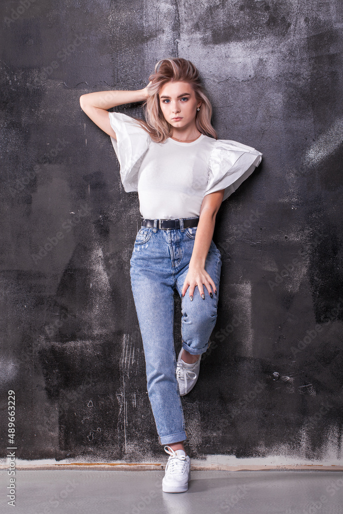 Fashion portrait of a young beautiful blonde girl